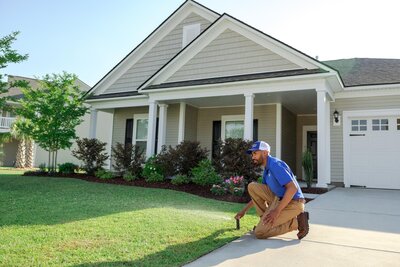 Man adjusting sprinkler for Irrigation Repair and Maintenance Services